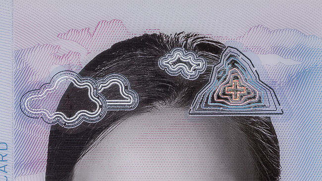 Image of a laserable KINEGRAM ZERO.ZERO feature, showing that Laserable KINEGRAM ZERO.ZERO, showing that after personalization with special laser equipment, the metallic fine lines still maintain their optical effects.