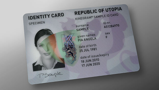 Image of polycarbonate ID card with embedded KINEGRAM showing a red-green flip effect, this enables easy ID verification